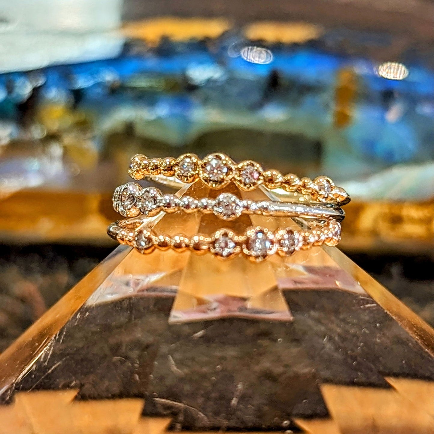Photo of "Chloe" Stackable Band in a decorative scene, designed by , available at Plumb Gold & Plumb Silver