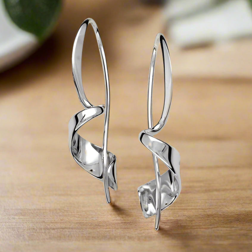 Photo of "Corkscrew" Earrings in a decorative scene, designed by , available at Plumb Gold & Plumb Silver
