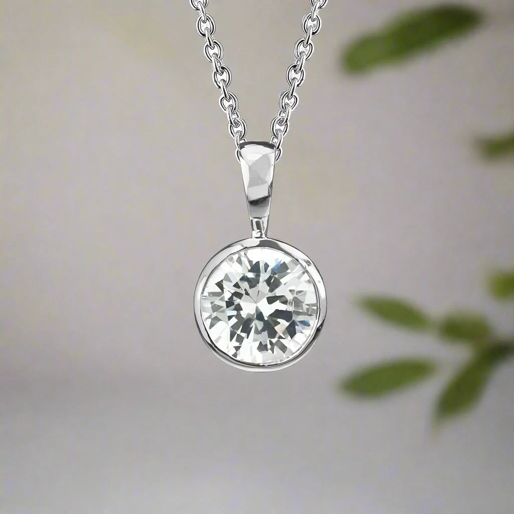 Photo of Cubic Zirconia Bezel Necklace in a decorative scene, designed by , available at Plumb Gold & Plumb Silver