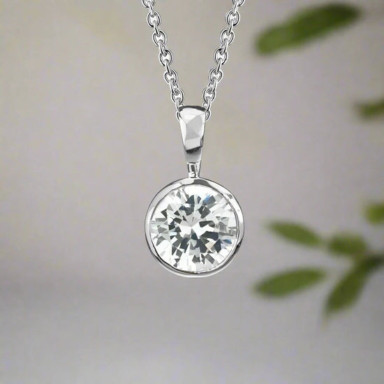 Photo of Cubic Zirconia Bezel Necklace in a decorative scene, designed by , available at Plumb Gold & Plumb Silver