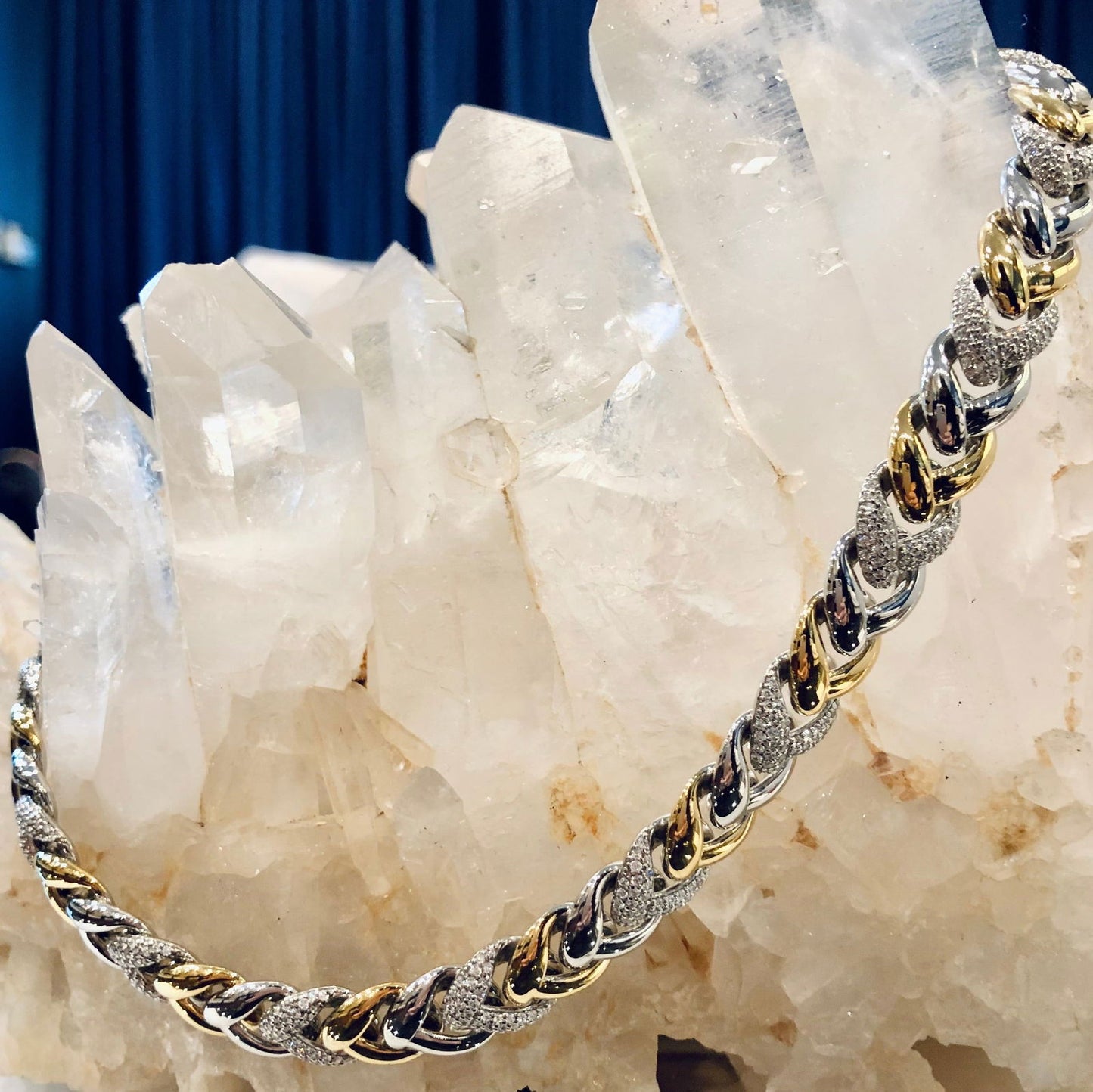 Photo of Cubic Zirconia Braided Link Necklace in a decorative scene, designed by , available at Plumb Gold & Plumb Silver