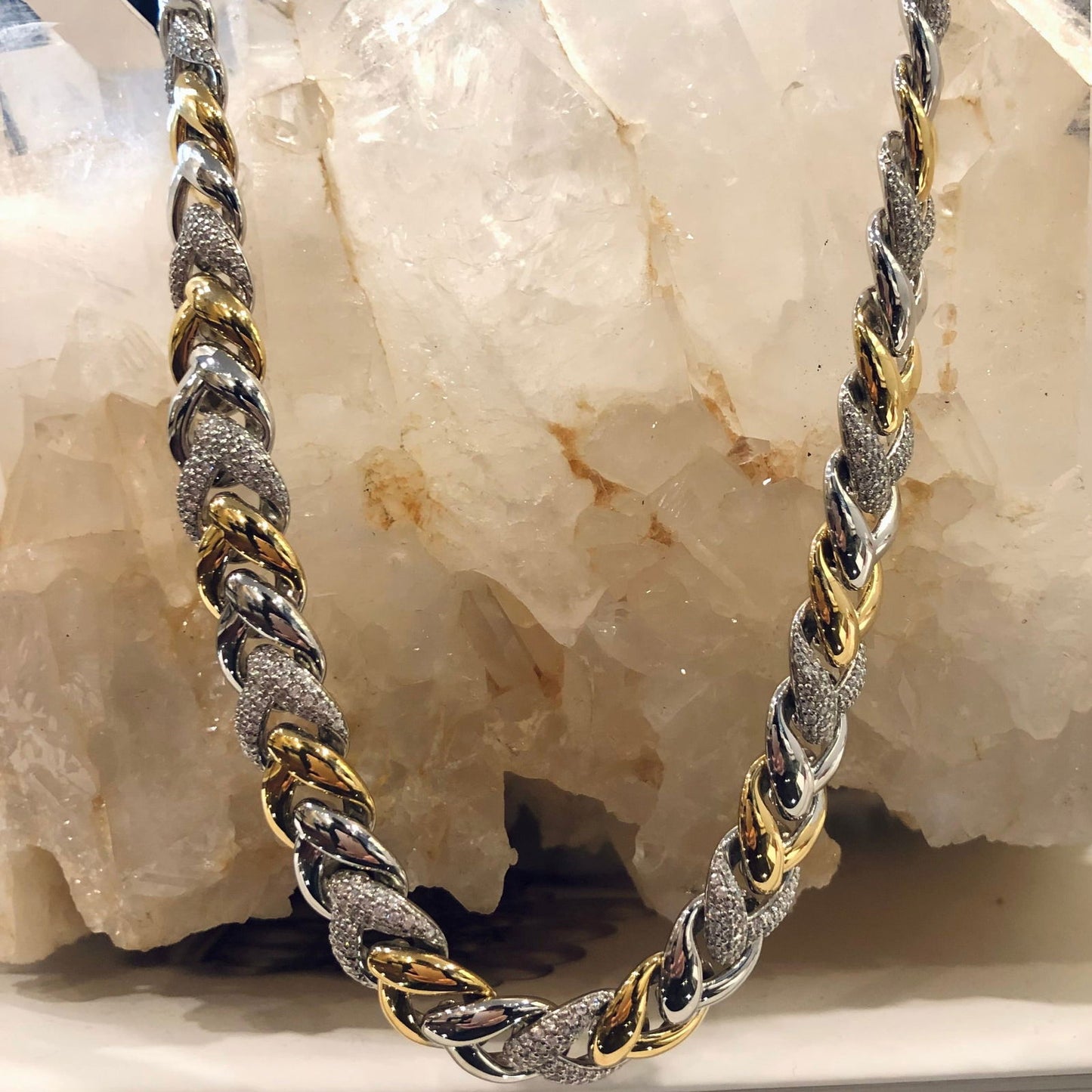 Photo of Cubic Zirconia Braided Link Necklace in a decorative scene, designed by , available at Plumb Gold & Plumb Silver