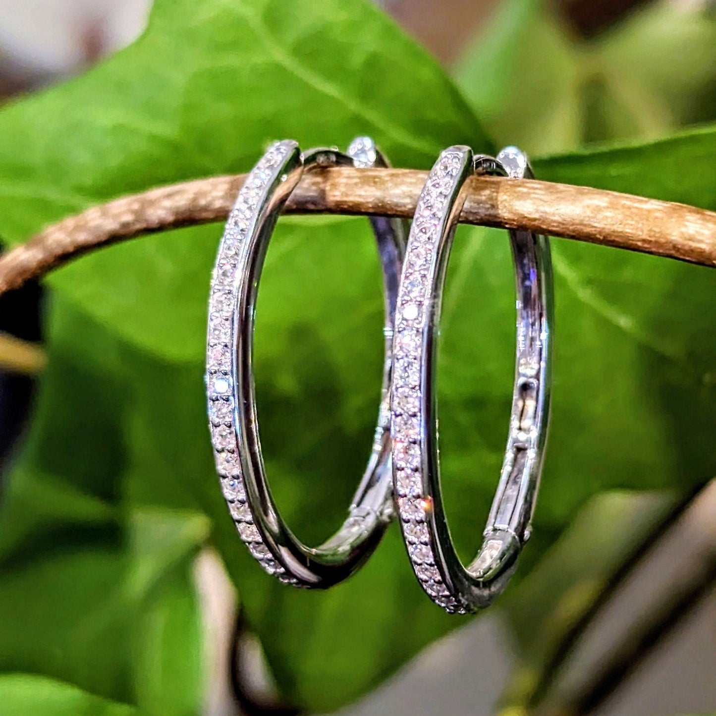 Photo of Cubic Zirconia Hoop Earrings in a decorative scene, designed by , available at Plumb Gold & Plumb Silver