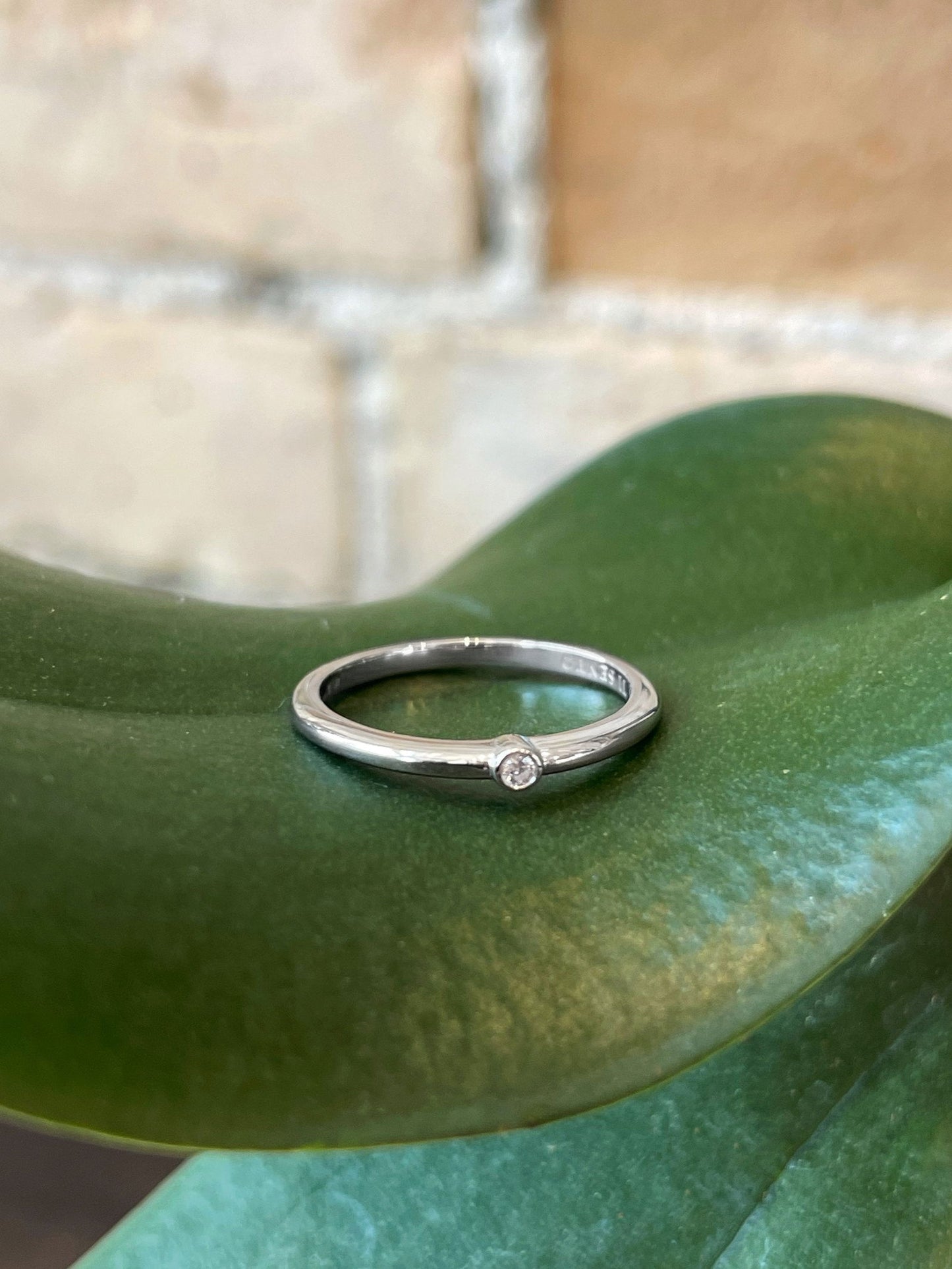 Photo of Cubic Zirconia Ring in a decorative scene, designed by , available at Plumb Gold & Plumb Silver