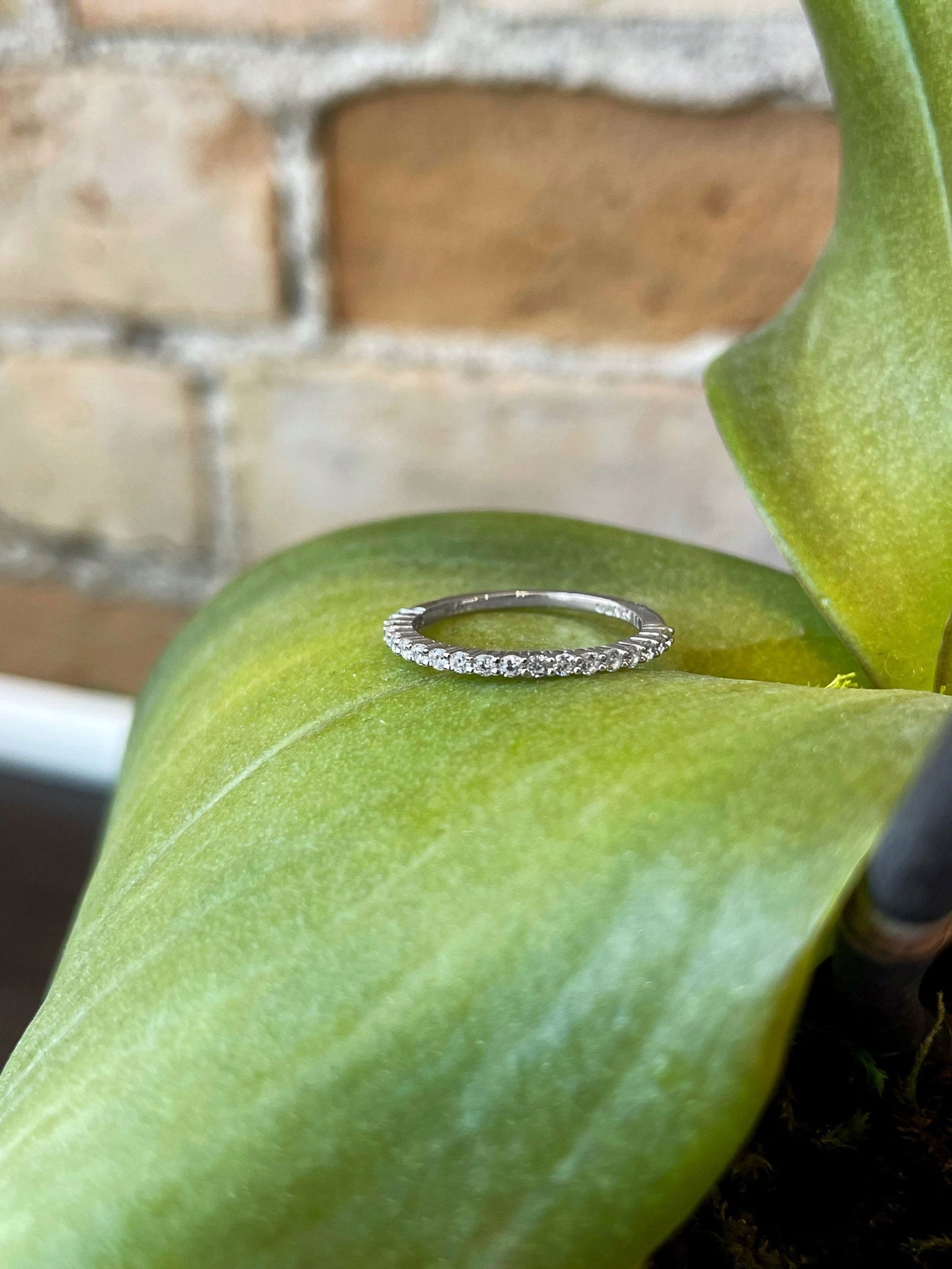 Photo of Cubic Zirconia Ring in a decorative scene, designed by , available at Plumb Gold & Plumb Silver