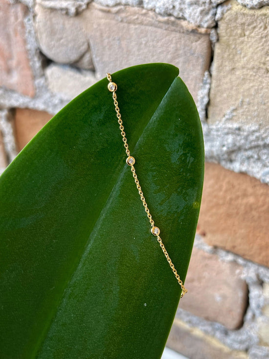 Photo of Cubic Zirconia Station Bracelet in a decorative scene, designed by , available at Plumb Gold & Plumb Silver