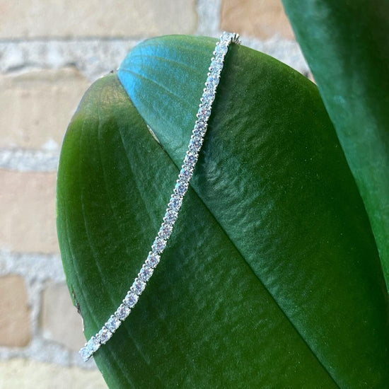 Photo of Cubic Zirconia Tennis Bracelet in a decorative scene, designed by , available at Plumb Gold & Plumb Silver