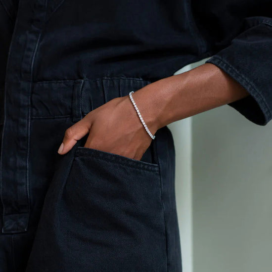 Photo of Cubic Zirconia Tennis Bracelet in a decorative scene, designed by , available at Plumb Gold & Plumb Silver