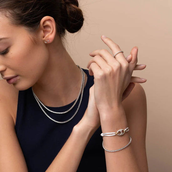 Photo of Cubic Zirconia Tennis Bracelet in a decorative scene, designed by , available at Plumb Gold & Plumb Silver