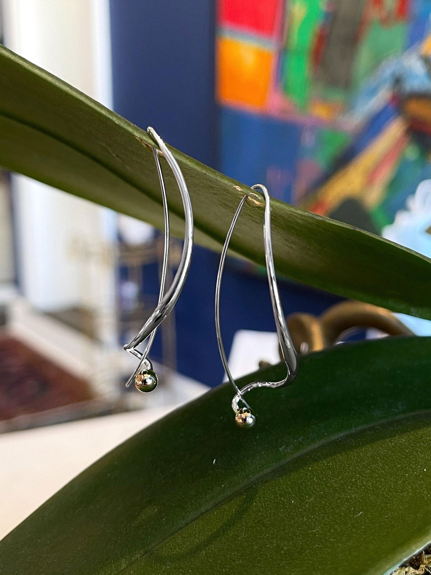 Photo of "Dangle" Earring in a decorative scene, designed by , available at Plumb Gold & Plumb Silver