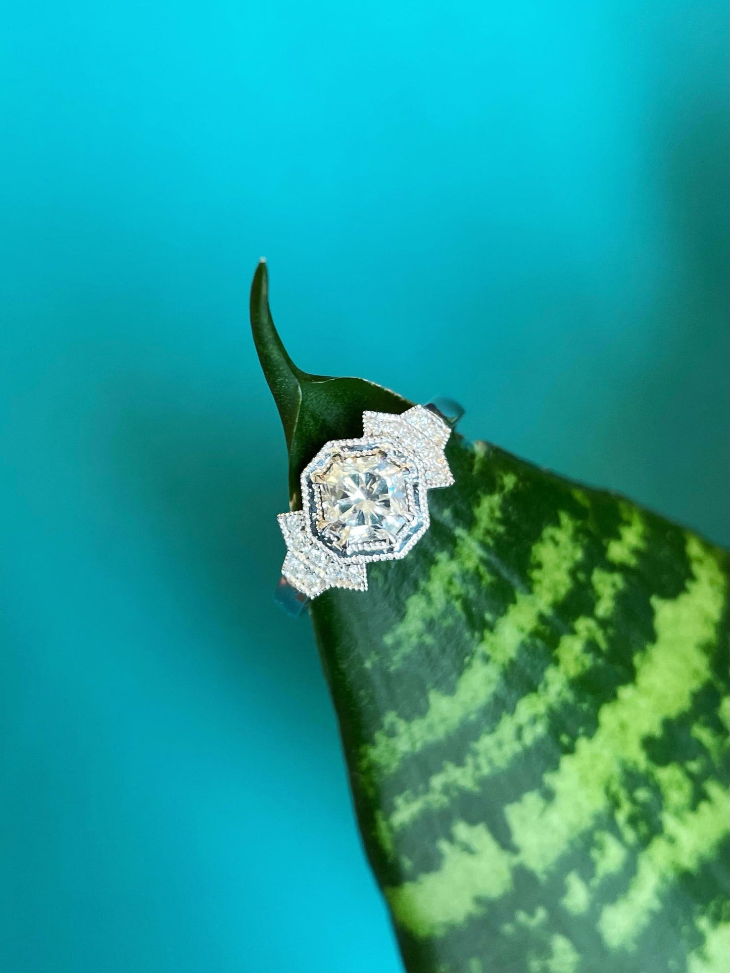 Photo of Diamond Art Deco Ring in a decorative scene, designed by , available at Plumb Gold & Plumb Silver