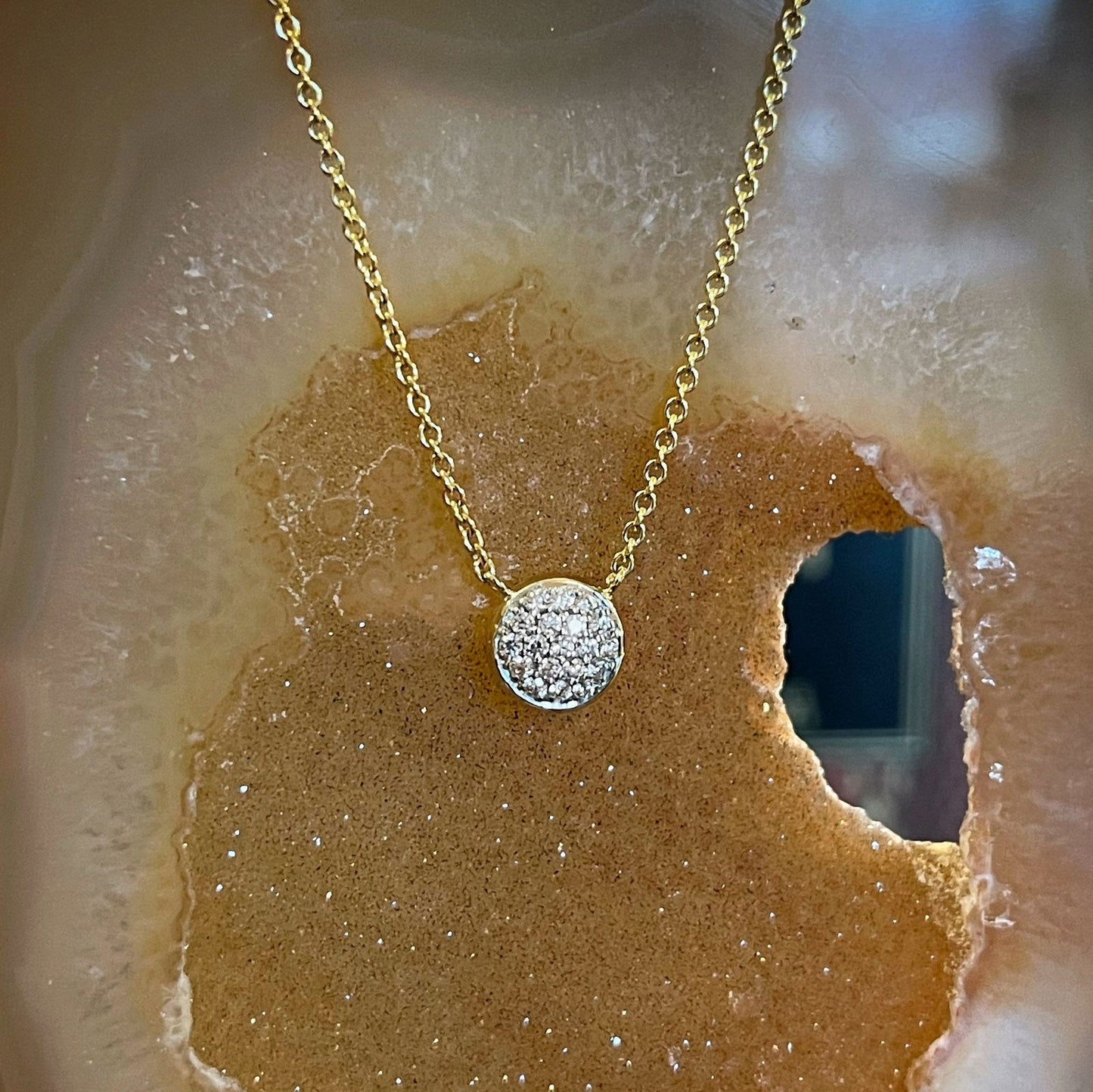 Photo of Diamond Cluster Necklace in a decorative scene, designed by , available at Plumb Gold & Plumb Silver