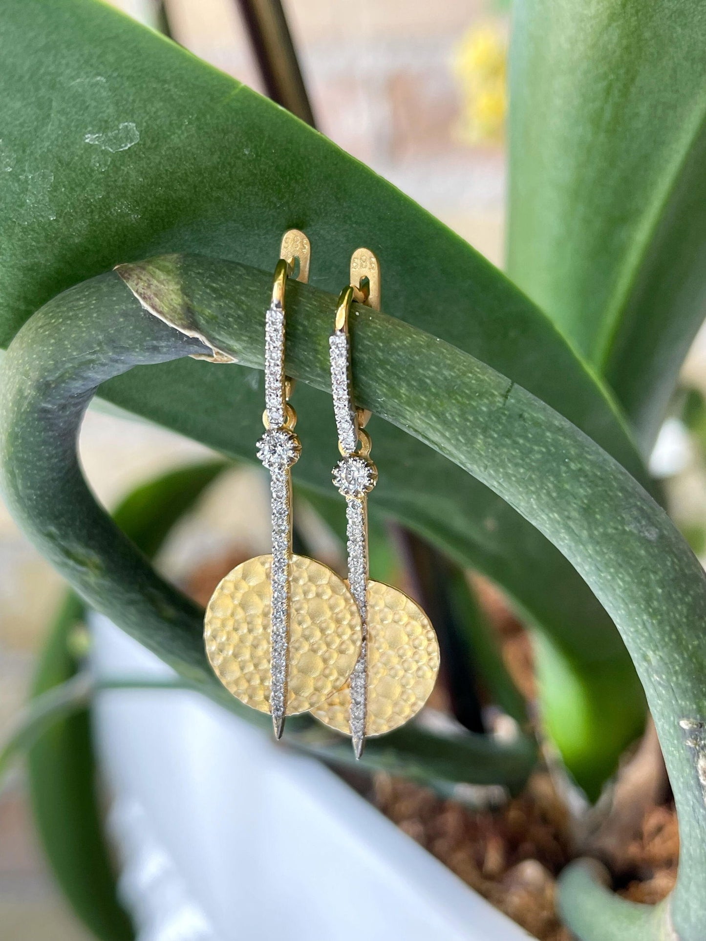 Photo of Diamond Drop Disk Earrings in a decorative scene, designed by , available at Plumb Gold & Plumb Silver