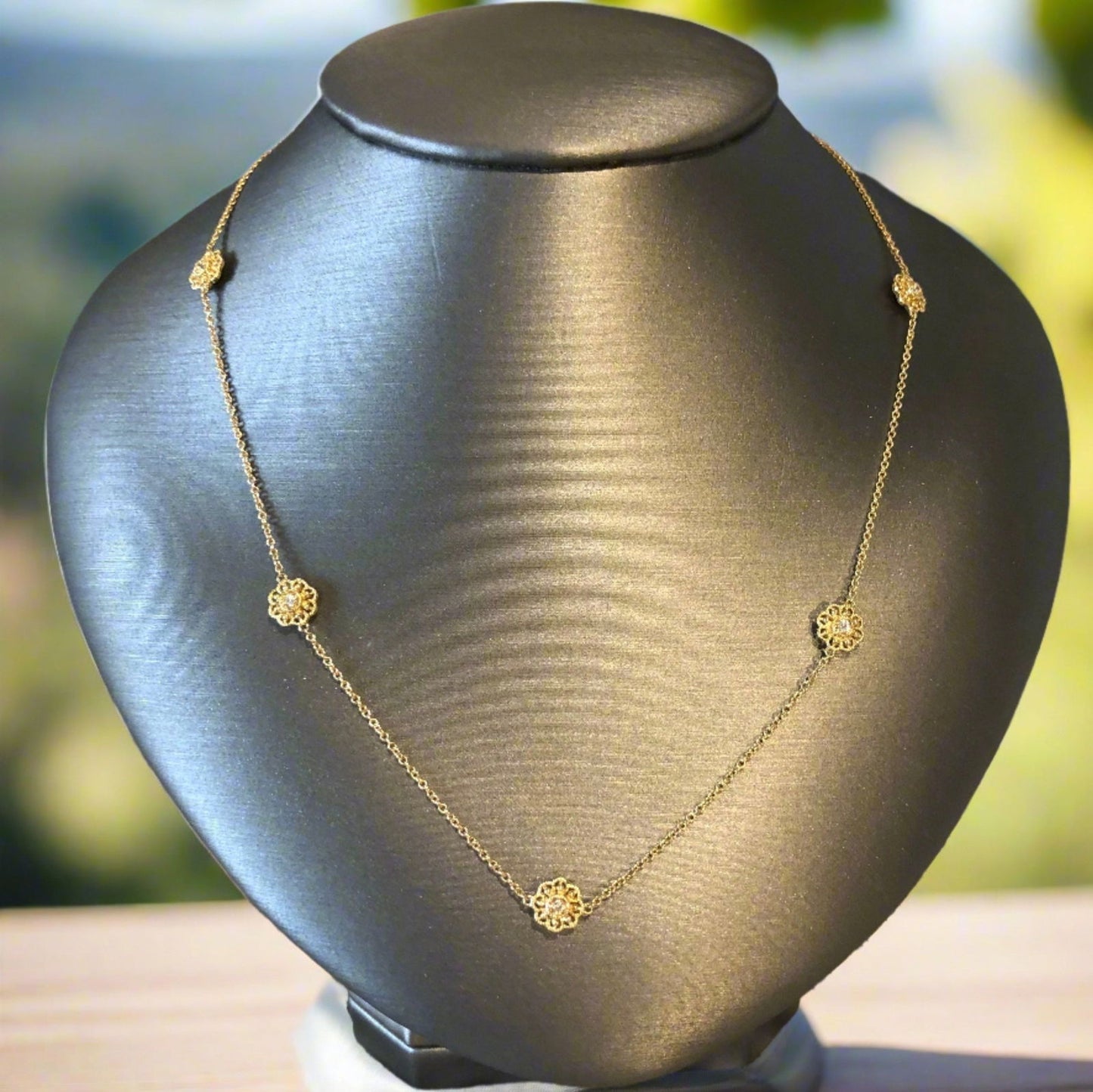 Photo of Diamond Flower Station Necklace in a decorative scene, designed by , available at Plumb Gold & Plumb Silver