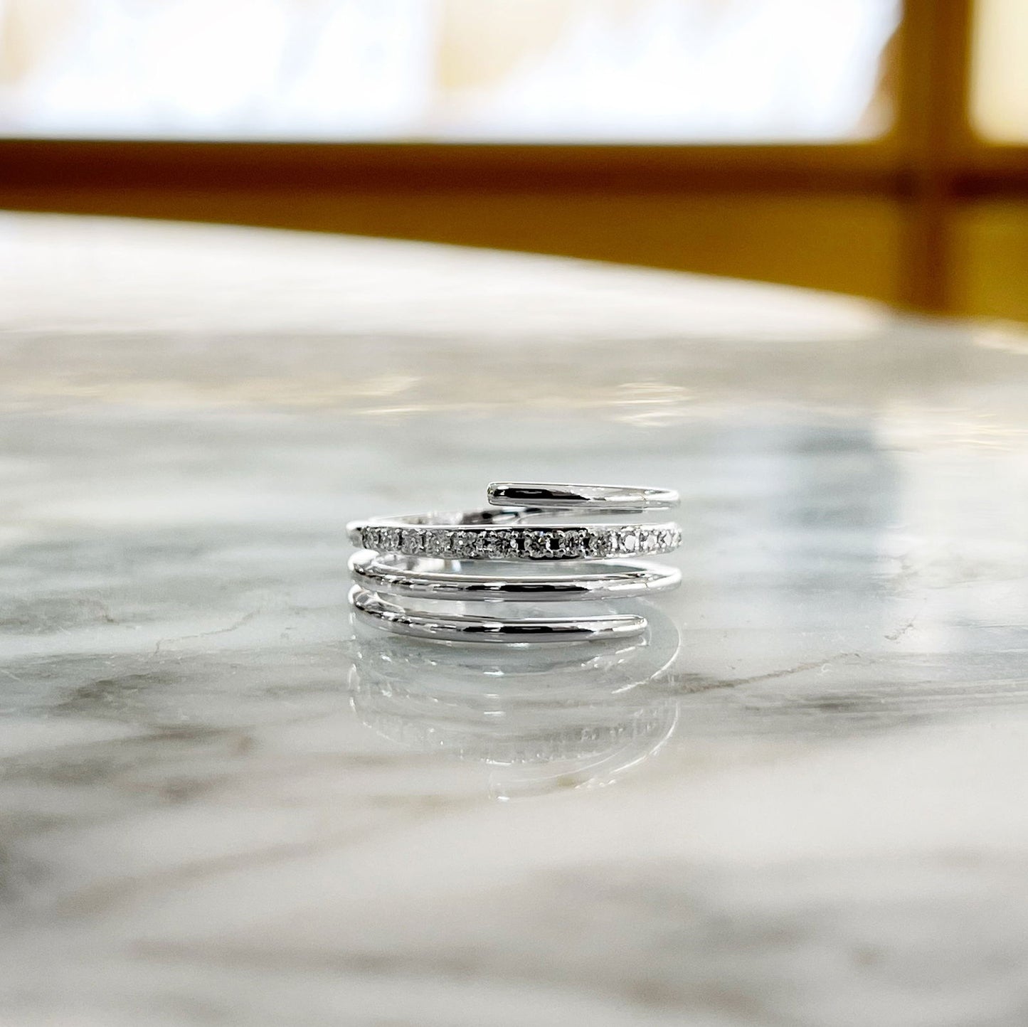 Photo of Diamond Line Ring in a decorative scene, designed by , available at Plumb Gold & Plumb Silver
