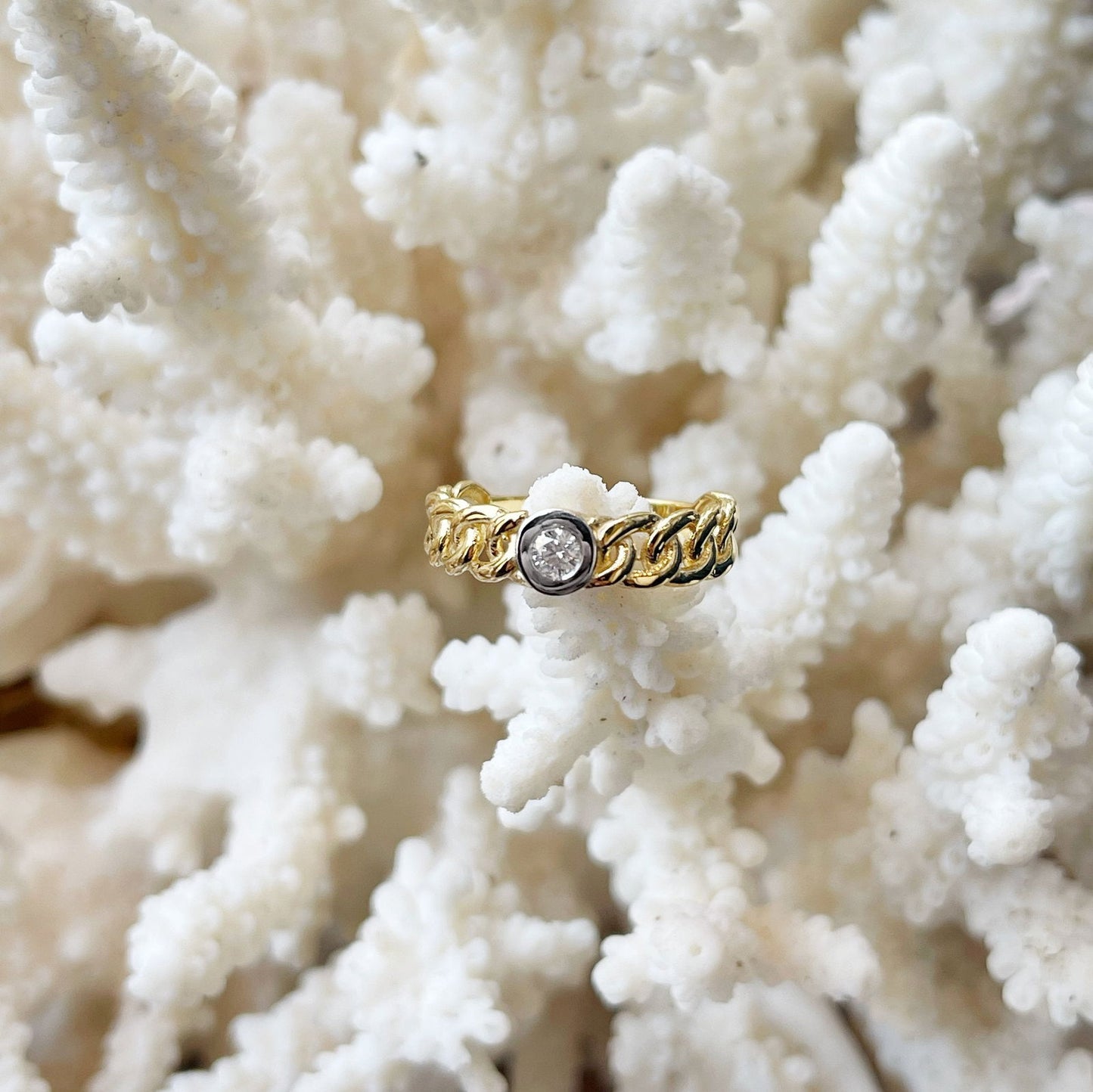 Photo of Diamond Link Ring in a decorative scene, designed by , available at Plumb Gold & Plumb Silver