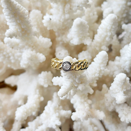 Photo of Diamond Link Ring in a decorative scene, designed by , available at Plumb Gold & Plumb Silver