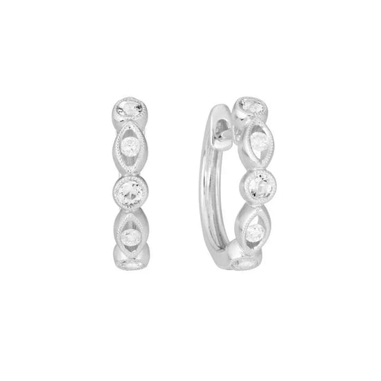 Photo of Diamond Milgrain Huggie Hoops in a decorative scene, designed by , available at Plumb Gold & Plumb Silver