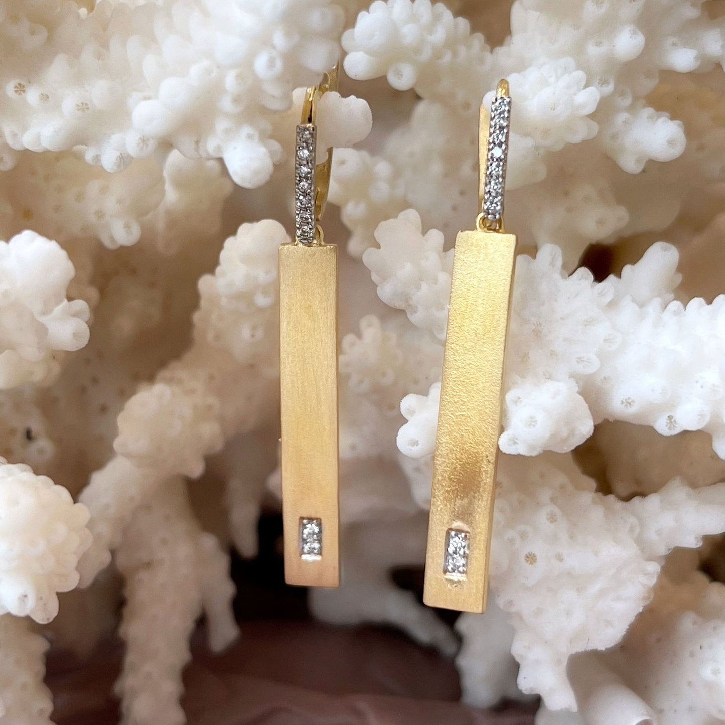 Photo of Diamond Rectangle Dangles in a decorative scene, designed by , available at Plumb Gold & Plumb Silver