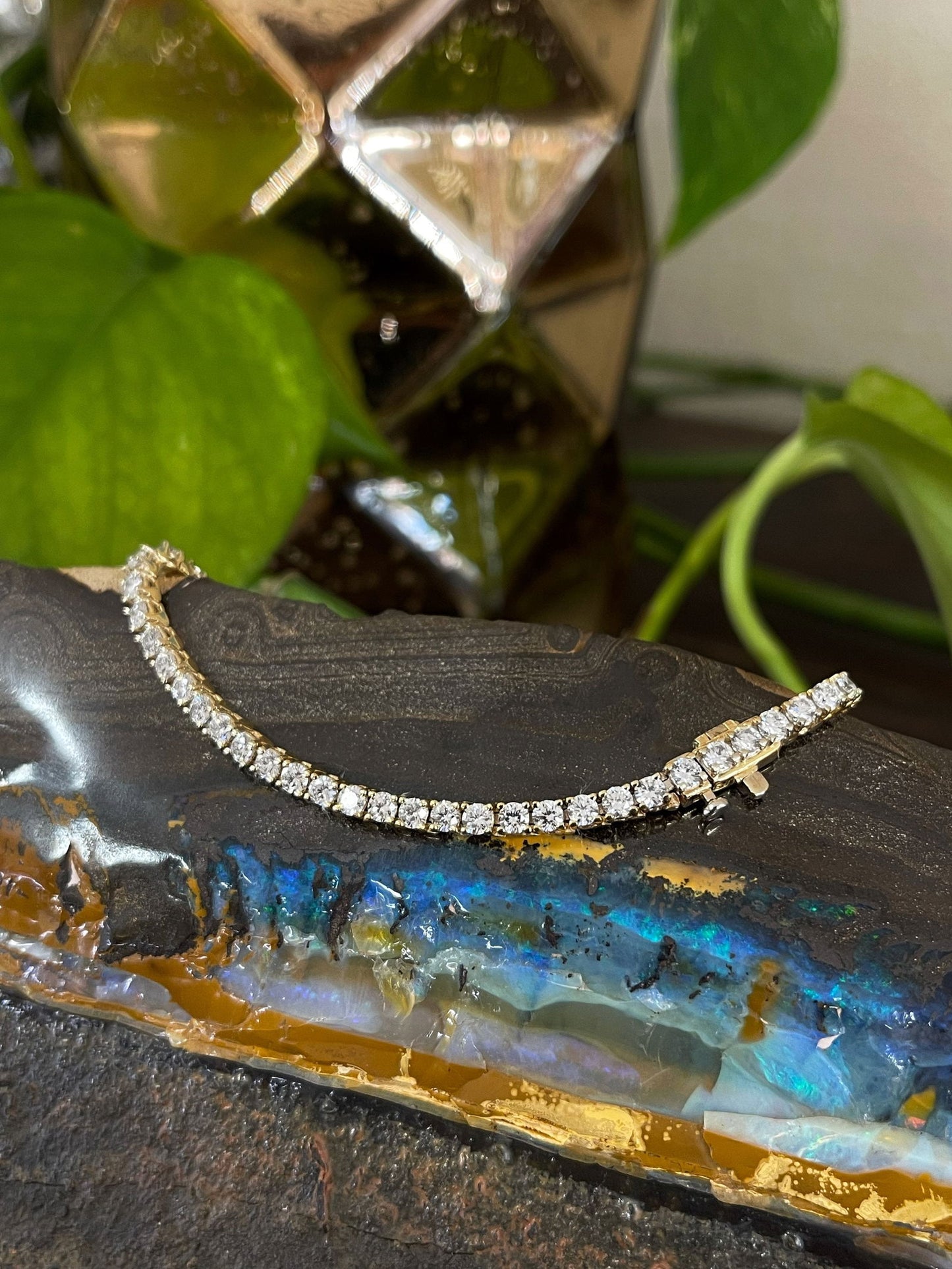 Photo of Diamond Tennis Bracelet in a decorative scene, designed by , available at Plumb Gold & Plumb Silver