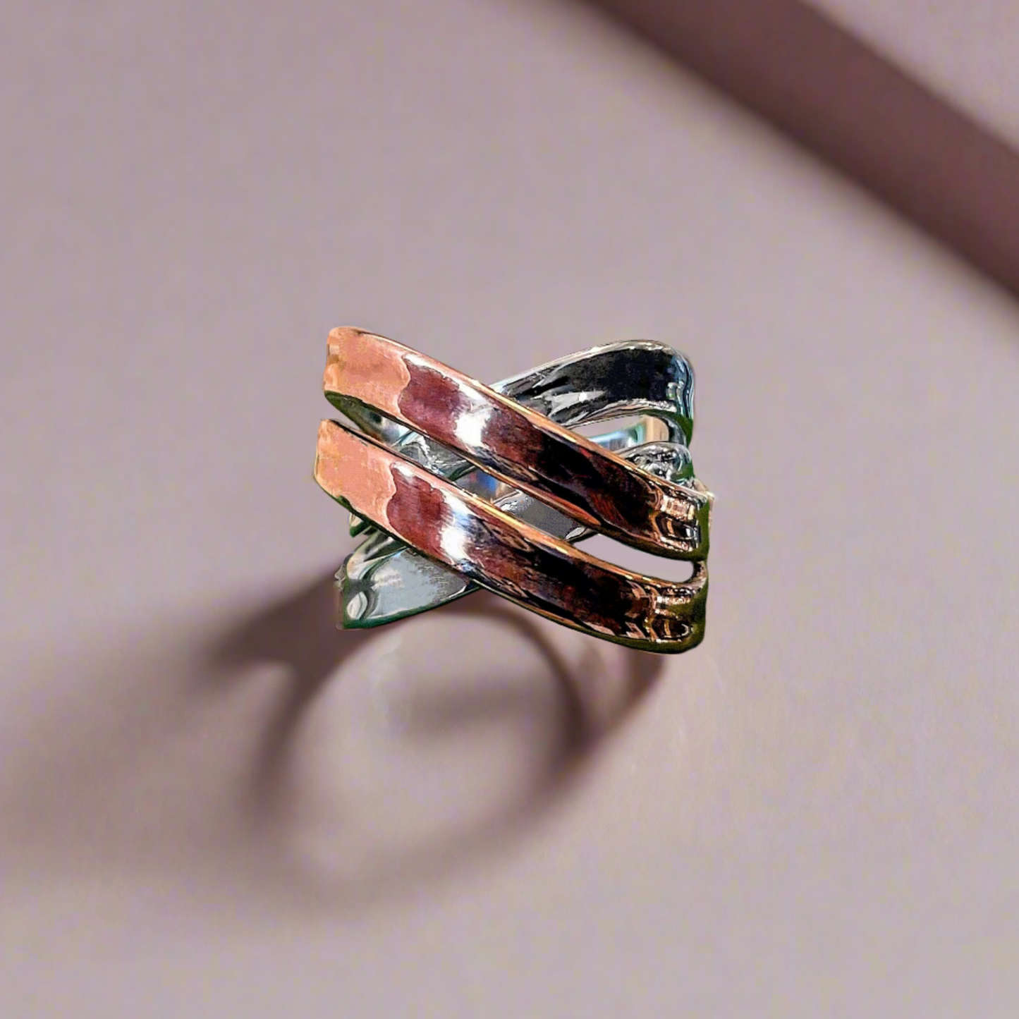 Photo of “Double Bridge” Ring in a decorative scene, designed by , available at Plumb Gold & Plumb Silver