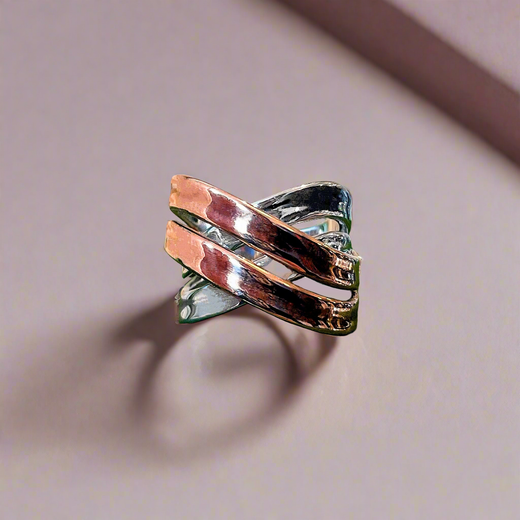 Photo of “Double Bridge” Ring in a decorative scene, designed by , available at Plumb Gold & Plumb Silver
