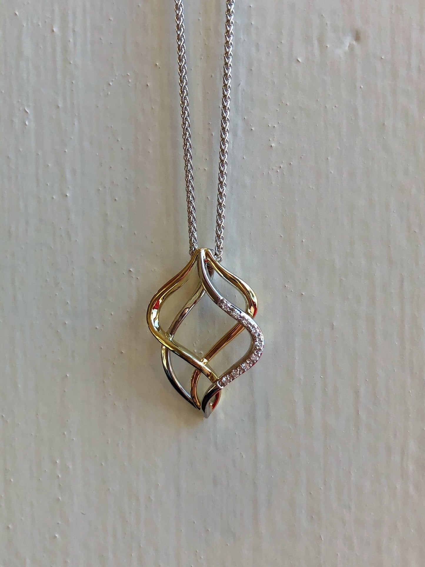 Photo of Double Open Pendant in a decorative scene, designed by , available at Plumb Gold & Plumb Silver