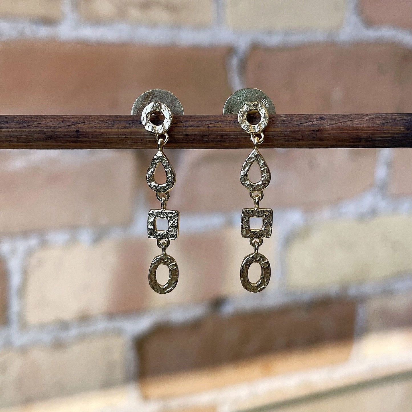 Photo of “Drop” Dangles in a decorative scene, designed by , available at Plumb Gold & Plumb Silver