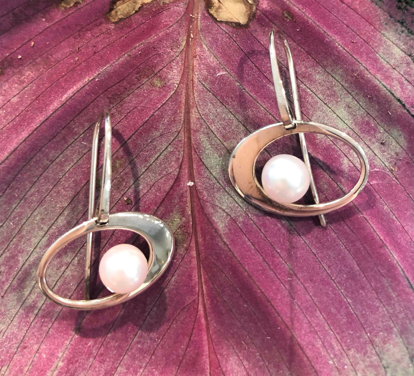 Photo of EL Designs "Paper Moon" Pearl Earrings in a decorative scene, designed by , available at Plumb Gold & Plumb Silver