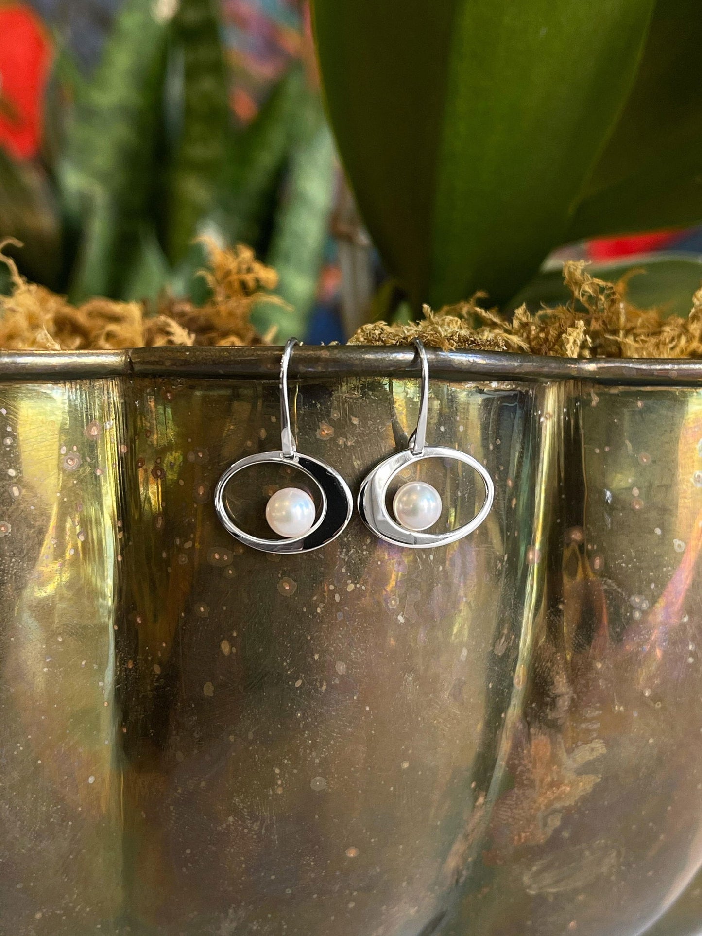 Photo of EL Designs "Paper Moon" Pearl Earrings in a decorative scene, designed by , available at Plumb Gold & Plumb Silver
