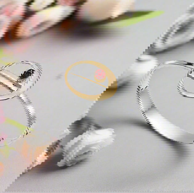 Photo of "Elliptical" Bracelet in a decorative scene, designed by , available at Plumb Gold & Plumb Silver