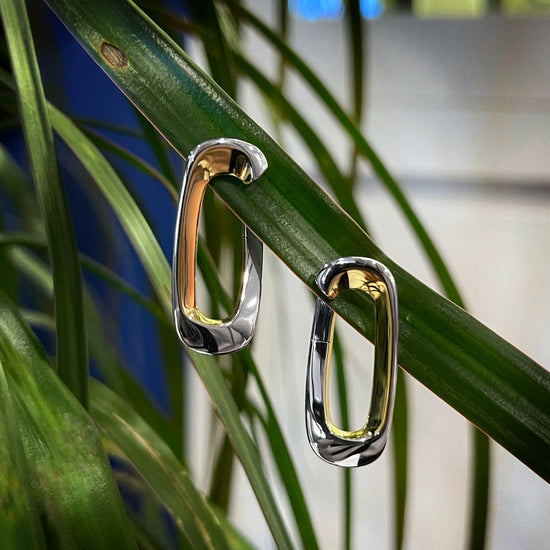 Photo of Elongated Oval Earrings in a decorative scene, designed by , available at Plumb Gold & Plumb Silver