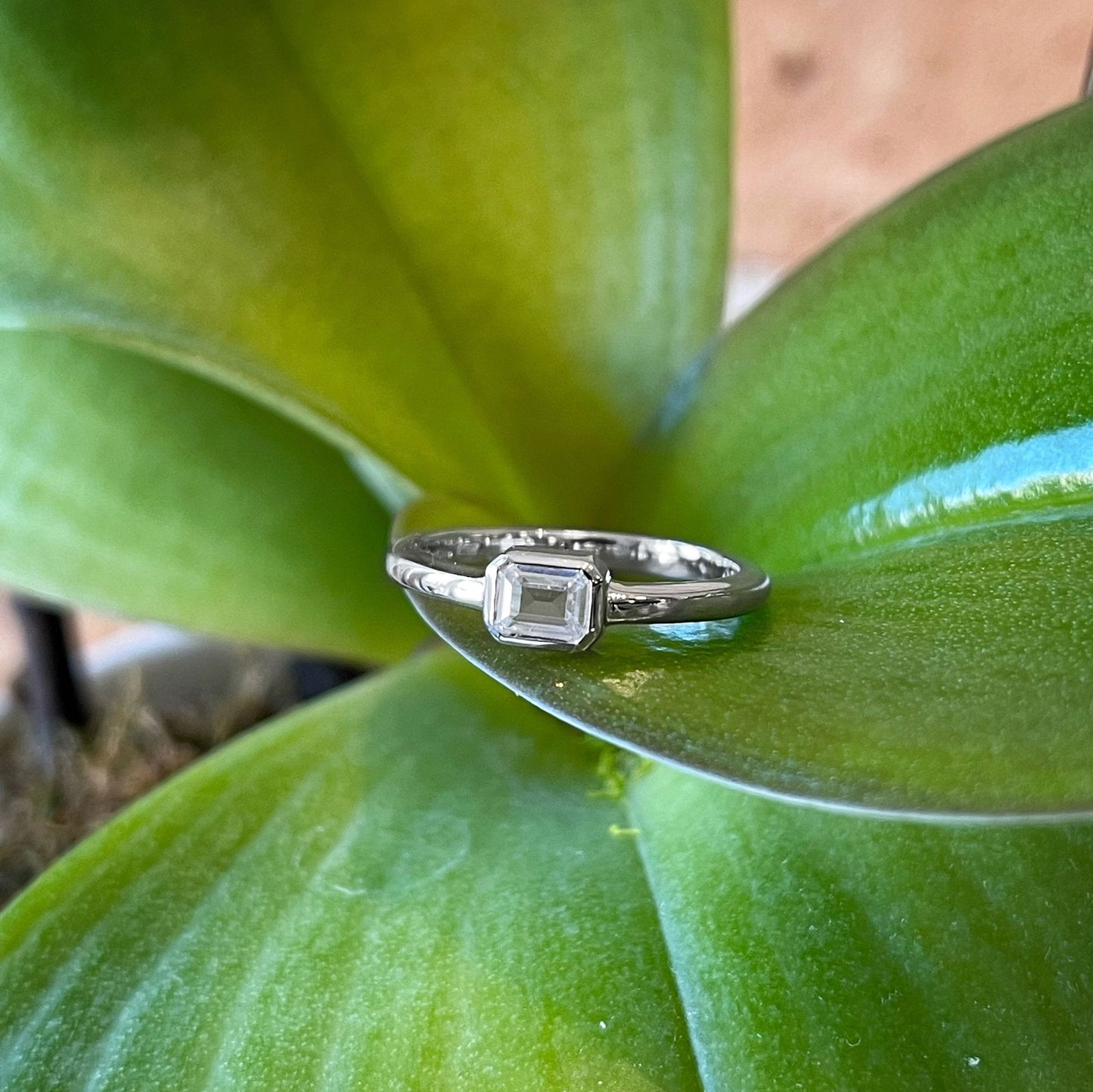 Photo of Emerald-Cut Cubic Zirconia Ring in a decorative scene, designed by , available at Plumb Gold & Plumb Silver