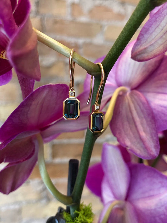Photo of Emerald Octagon-Cut London Blue Topaz and Diamond Dangles in a decorative scene, designed by , available at Plumb Gold & Plumb Silver