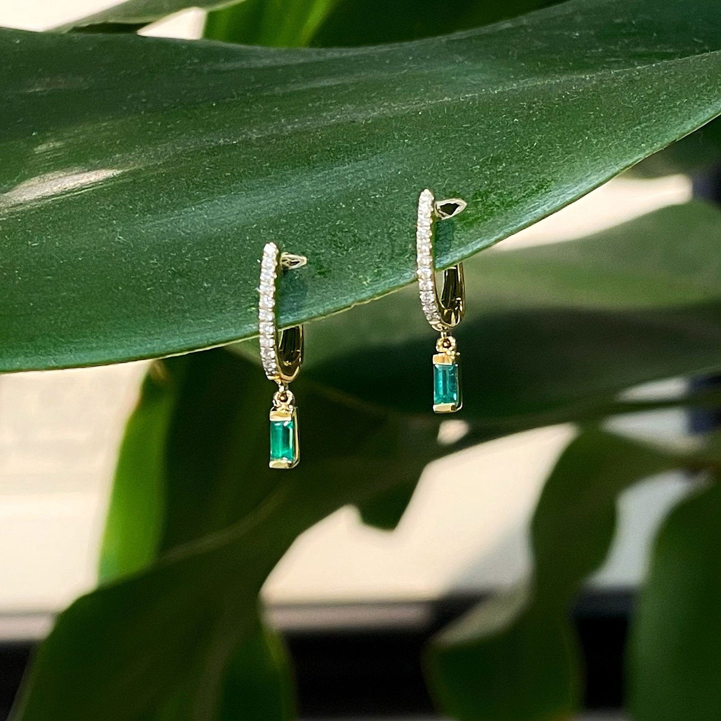 Photo of Emerald and Diamond Dangles in a decorative scene, designed by , available at Plumb Gold & Plumb Silver