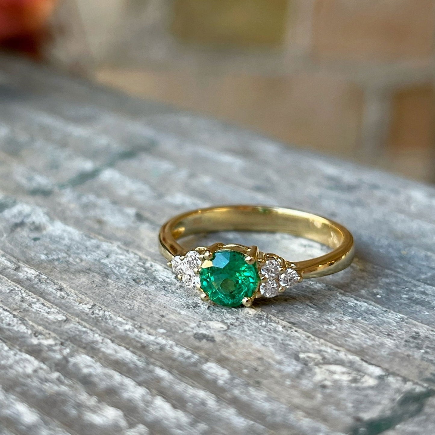 Photo of Emerald and Diamond Ring in a decorative scene, designed by , available at Plumb Gold & Plumb Silver