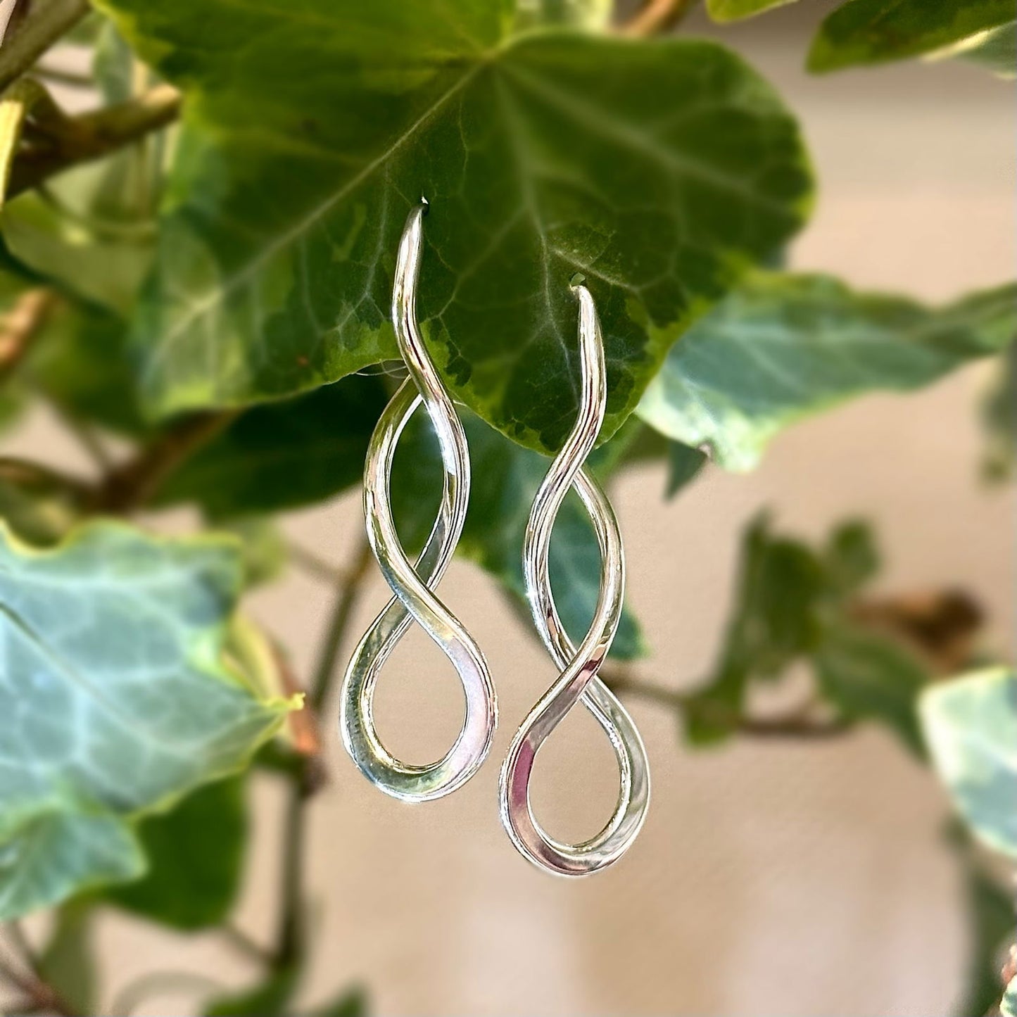 Earrings hanging from green vine