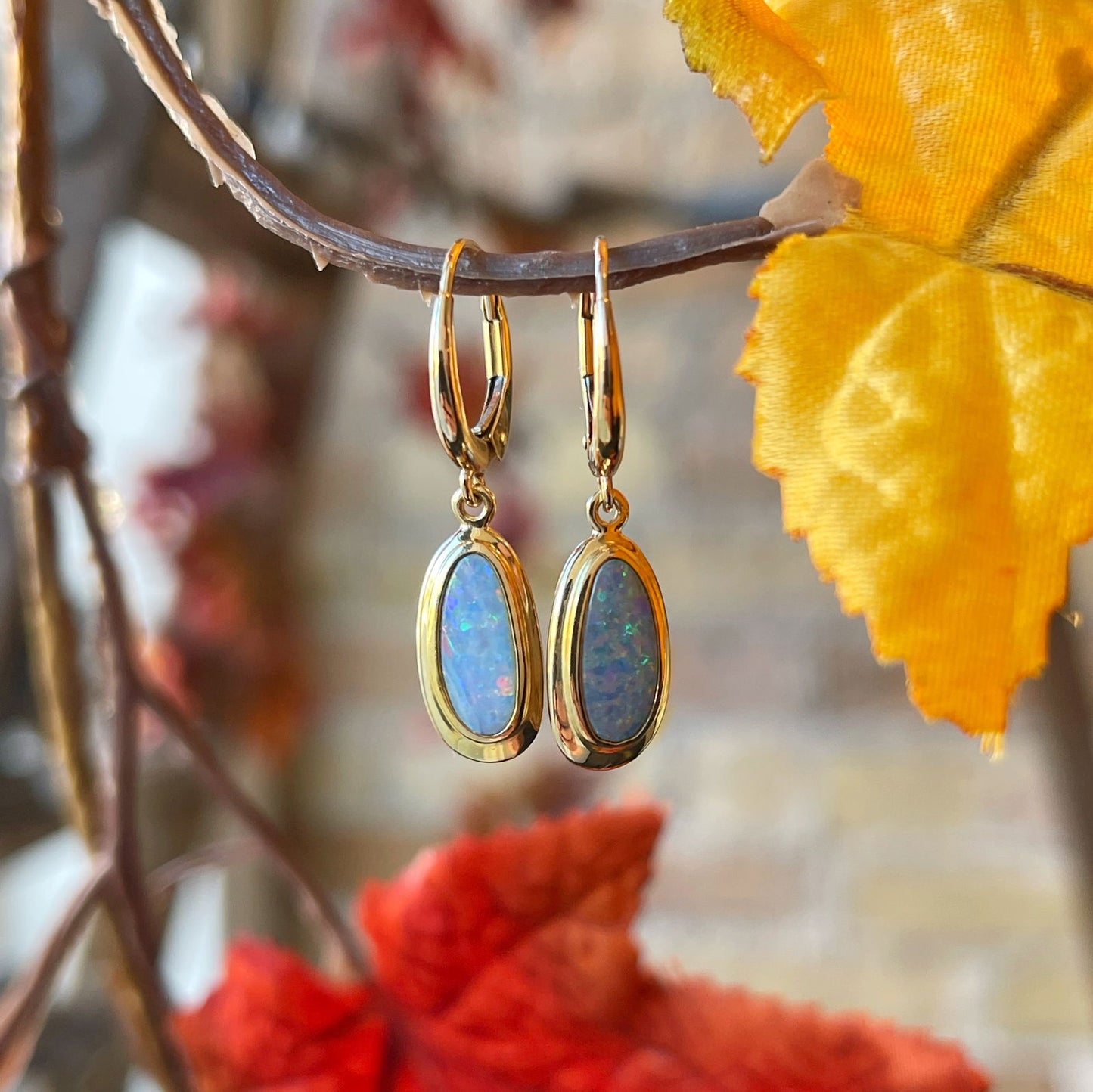 Photo of Ethiopian Opal Dangles in a decorative scene, designed by , available at Plumb Gold & Plumb Silver