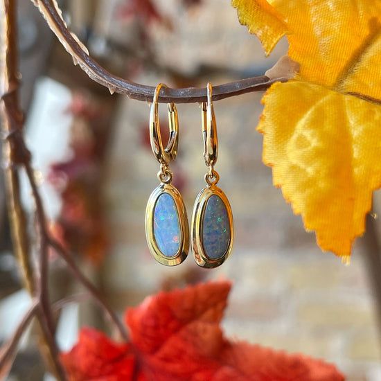 Photo of Ethiopian Opal Dangles in a decorative scene, designed by , available at Plumb Gold & Plumb Silver