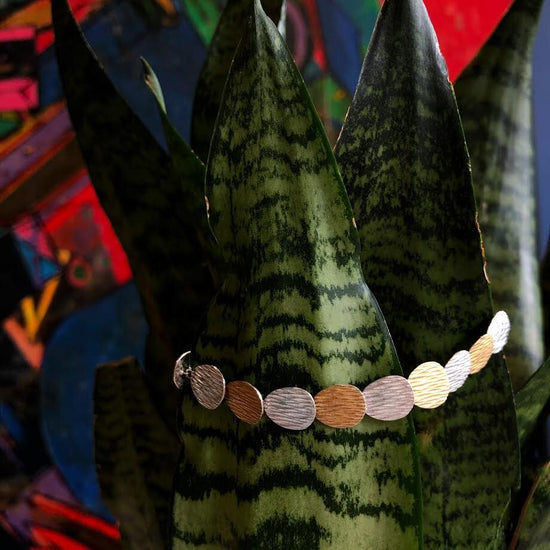 Photo of "Fall" Link Bracelet in a decorative scene, designed by , available at Plumb Gold & Plumb Silver