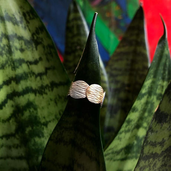 Photo of "Fall" Ring in a decorative scene, designed by , available at Plumb Gold & Plumb Silver
