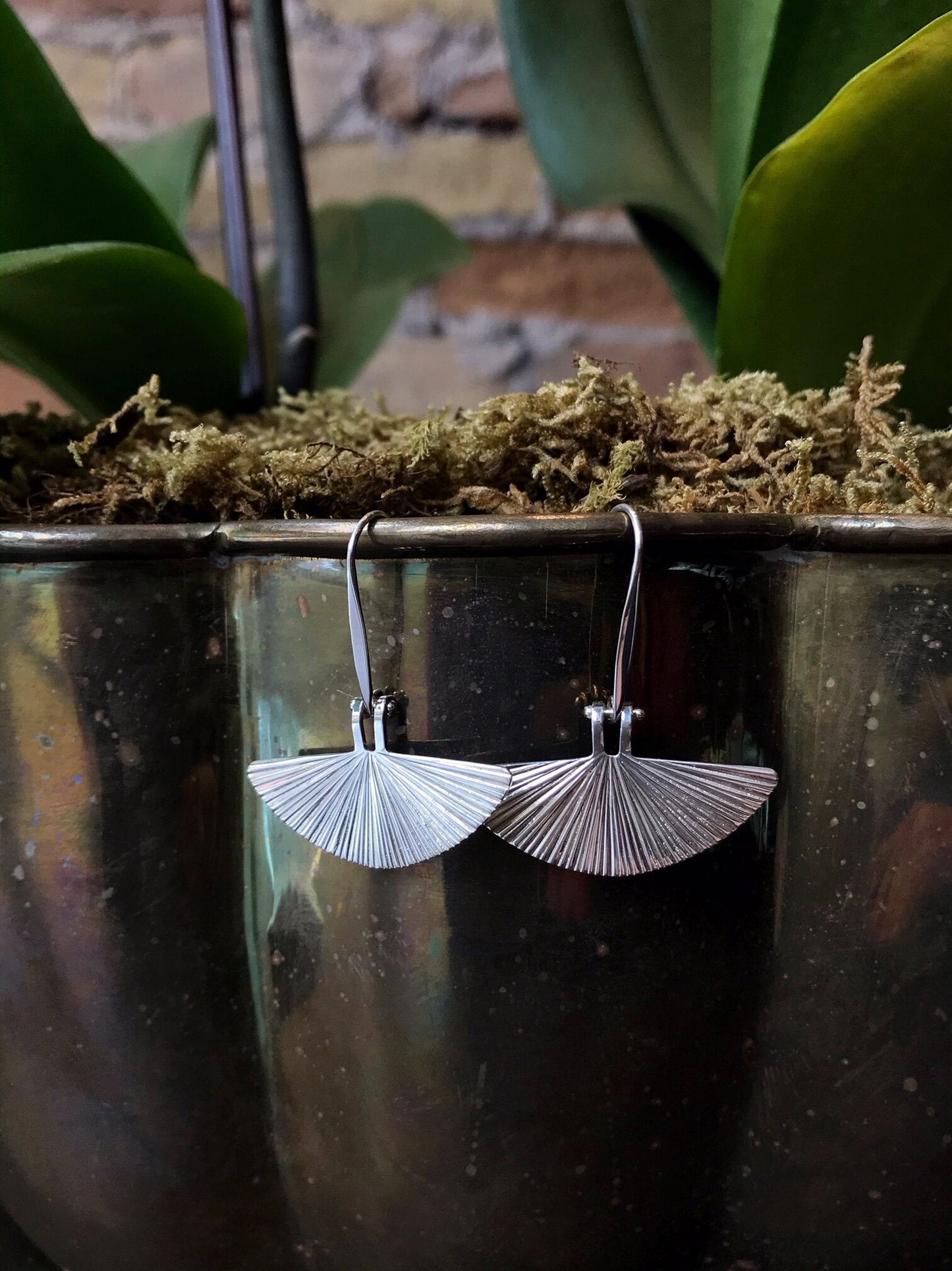 Photo of "Fan Dance" Earrings in a decorative scene, designed by , available at Plumb Gold & Plumb Silver