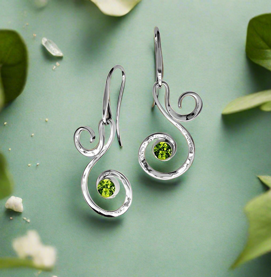 Photo of "Fiddlehead" Earrings in a decorative scene, designed by , available at Plumb Gold & Plumb Silver