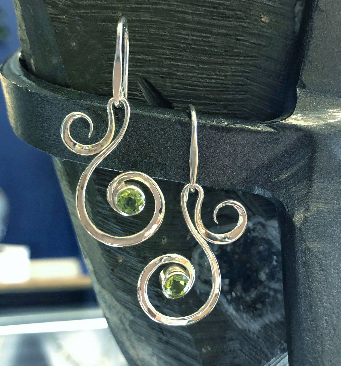 Photo of "Fiddlehead" Earrings in a decorative scene, designed by , available at Plumb Gold & Plumb Silver