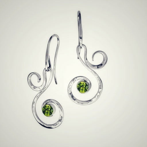 Photo of "Fiddlehead" Earrings in a decorative scene, designed by , available at Plumb Gold & Plumb Silver