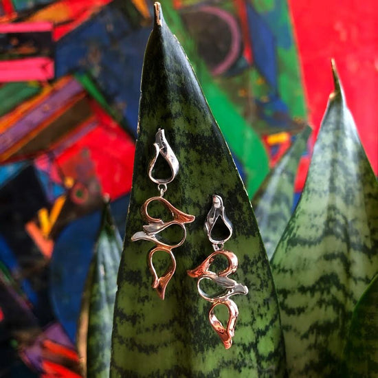 Photo of "Flames" Dangle Earrings in a decorative scene, designed by , available at Plumb Gold & Plumb Silver