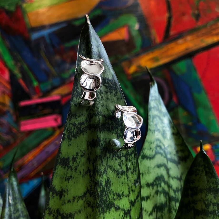 Photo of "Florida" C-Hoop Earring in a decorative scene, designed by , available at Plumb Gold & Plumb Silver