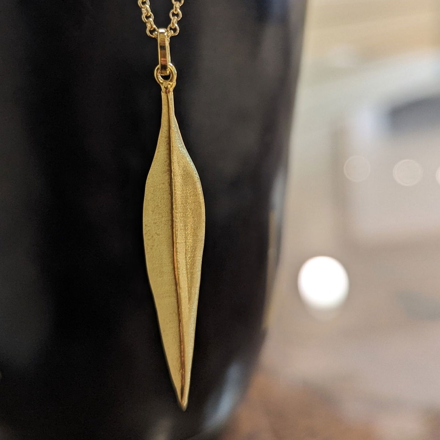Photo of "Forest" Pendant in a decorative scene, designed by , available at Plumb Gold & Plumb Silver