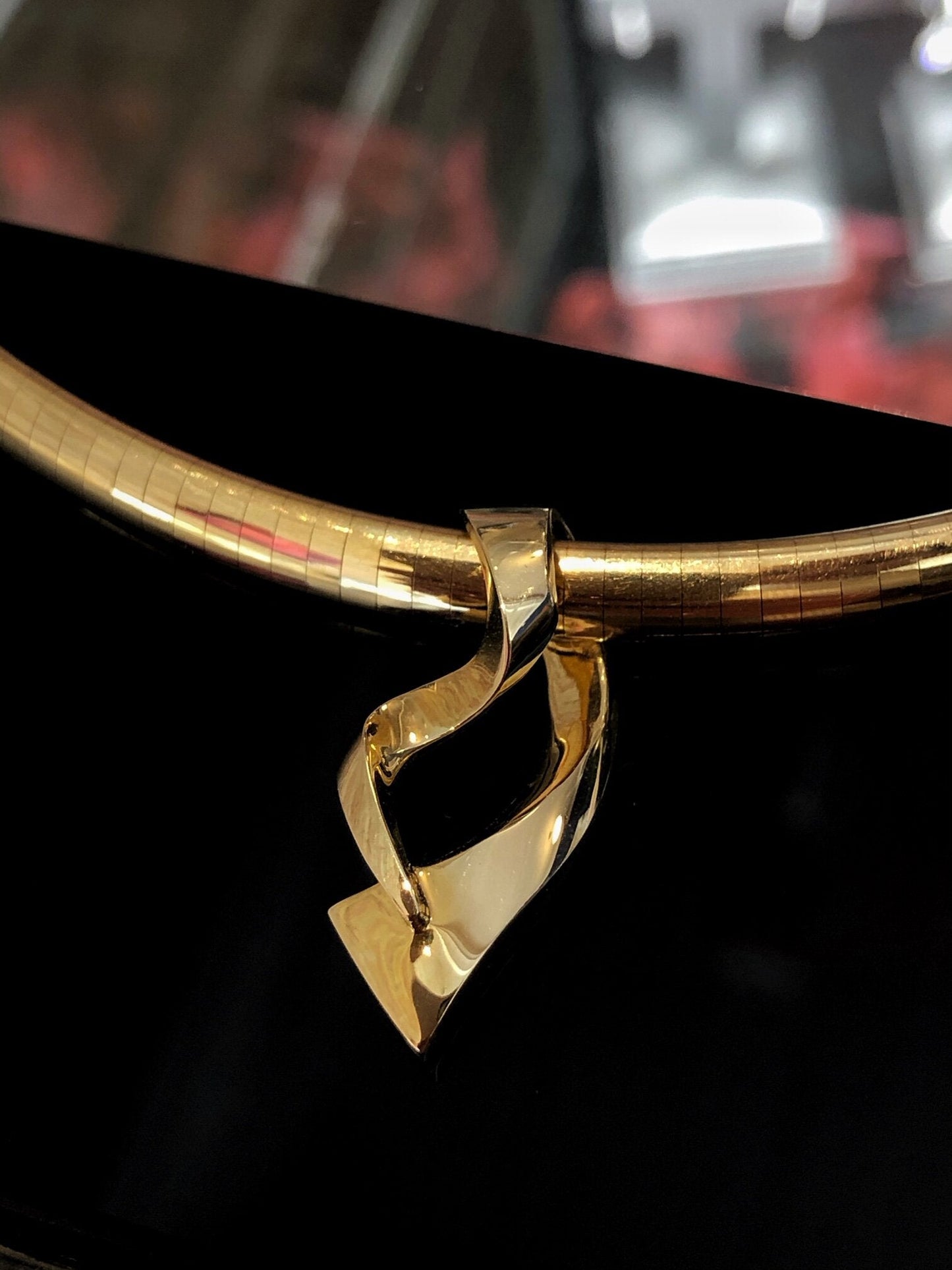 Photo of Freeform Slide Pendant in a decorative scene, designed by , available at Plumb Gold & Plumb Silver