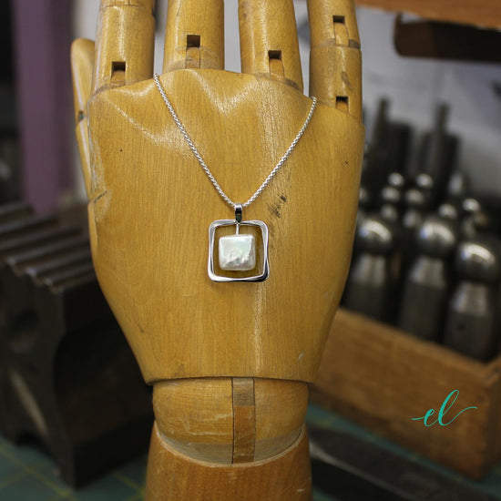 Photo of Freshwater Pearl "Zenith" Necklace in a decorative scene, designed by , available at Plumb Gold & Plumb Silver